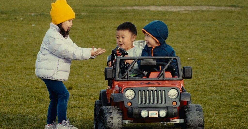 おもちゃの取り合いをせず、順番を守って遊んでいる3〜4歳の双子